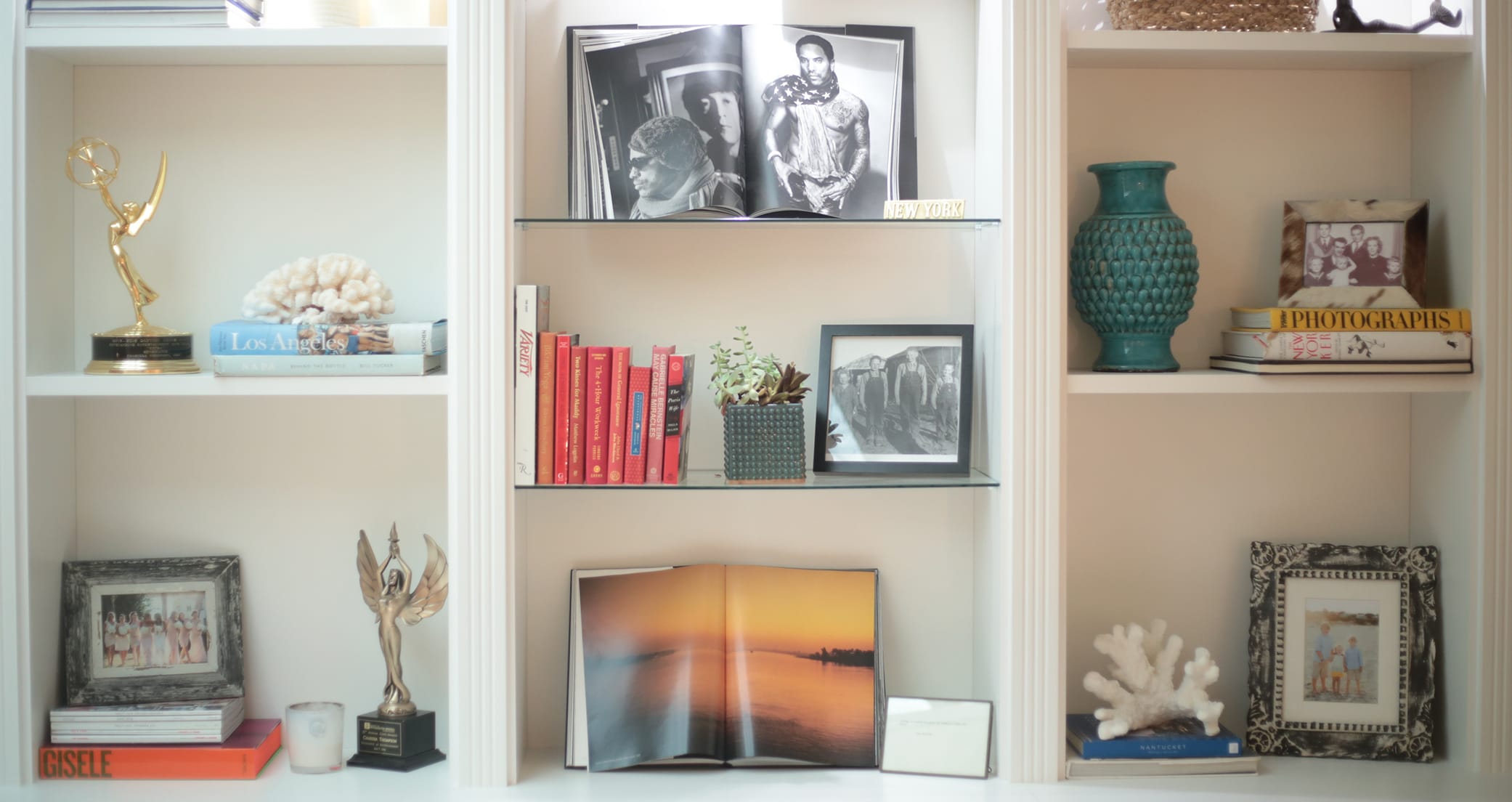 TV personality Charissa Thompson's classic white bookshelves displays photographs and trophies by California Closets