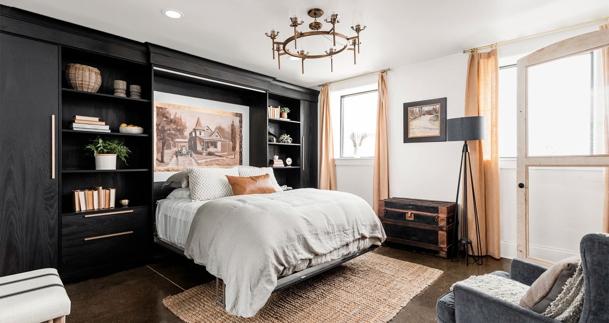 Custom wall bed with built in shelving and cabinets in dark finish designed by California Closets