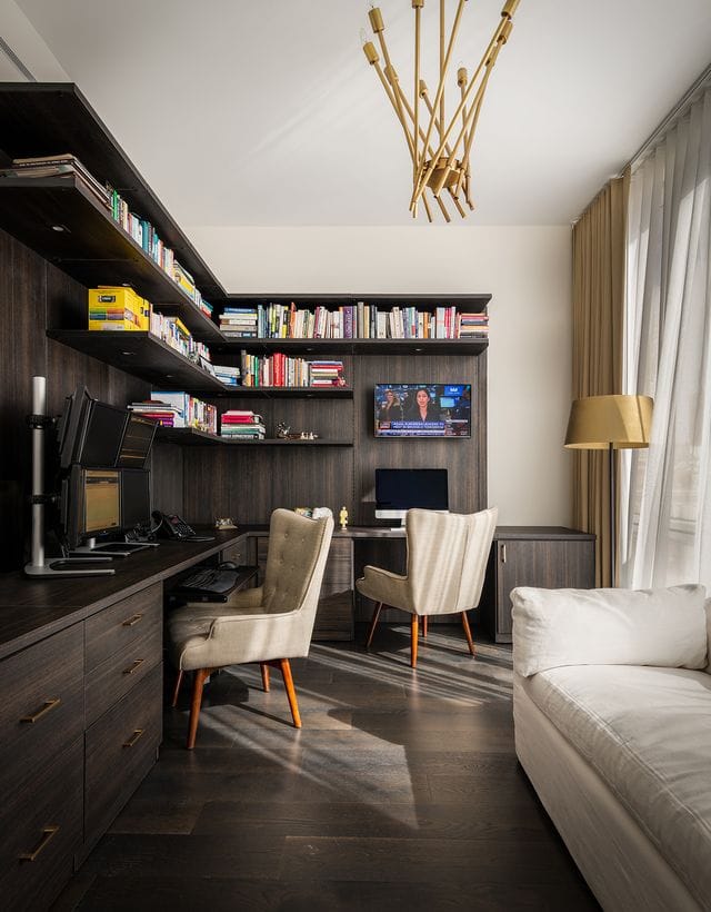 L-shaped workstations for home office with custom bookcases, drawers with gold hardware and cabinetry by California Closets