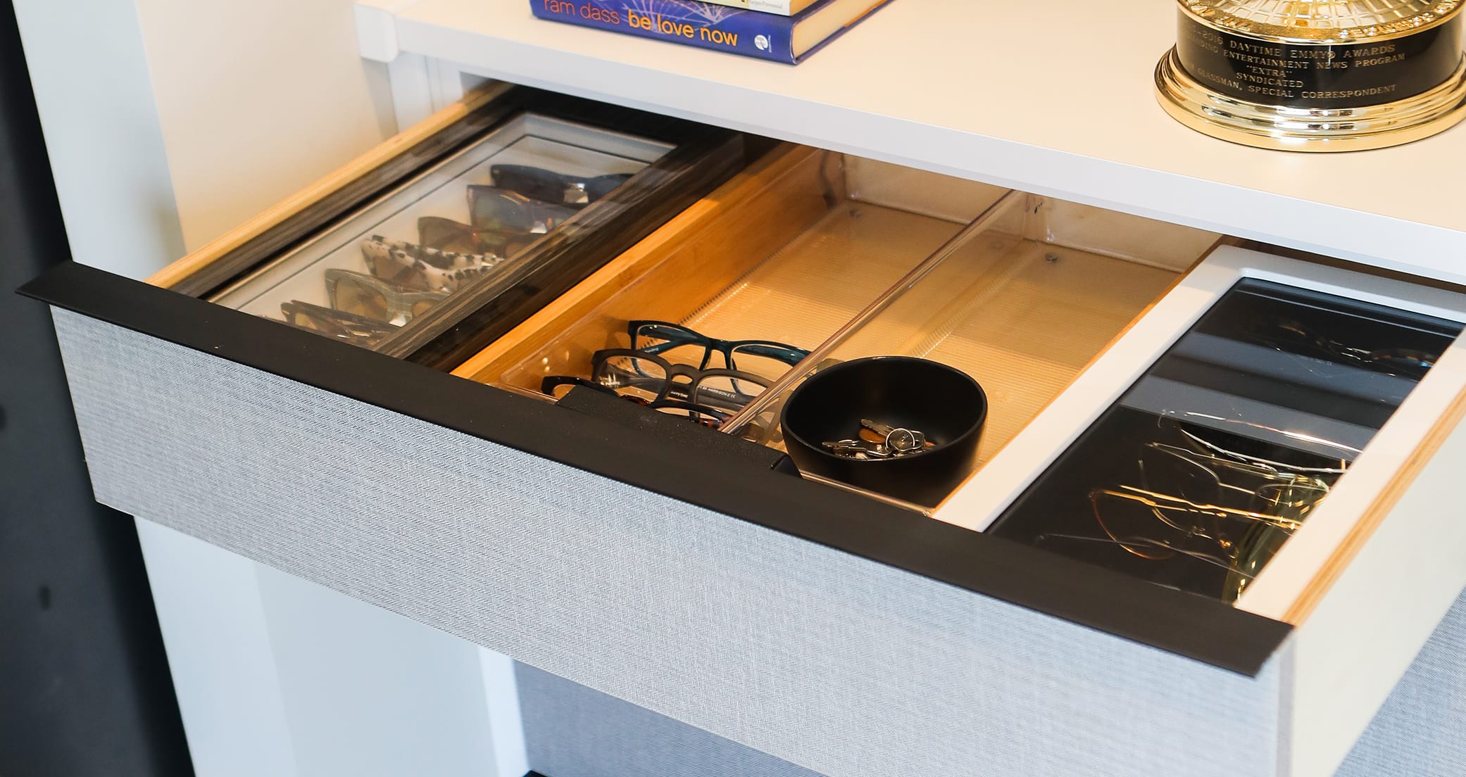 Custom pull out accessory drawer with organizers for sunglasses by California Closets
