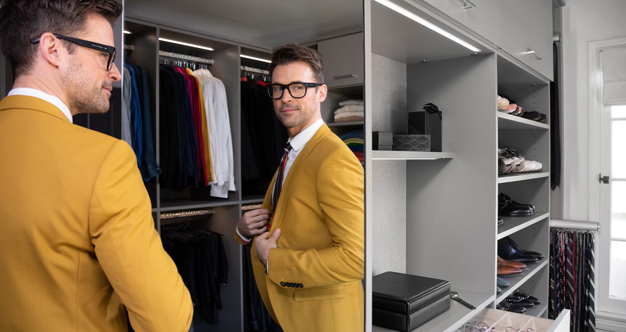 Fashion host Brad Goreski in his custom walk in closet with built in dresser by California Closets