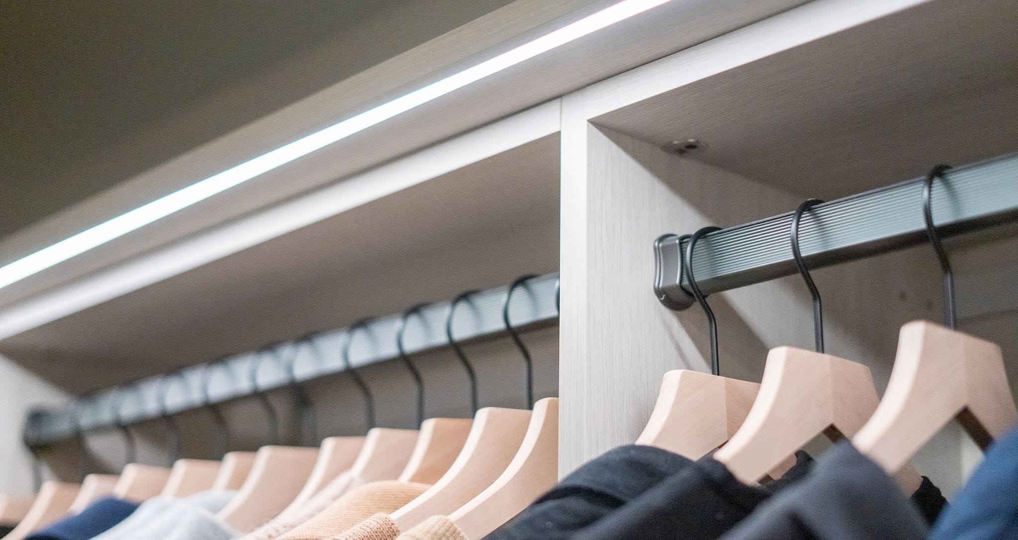 Closet clothing racks using ribbon LED lighting created by California Closets