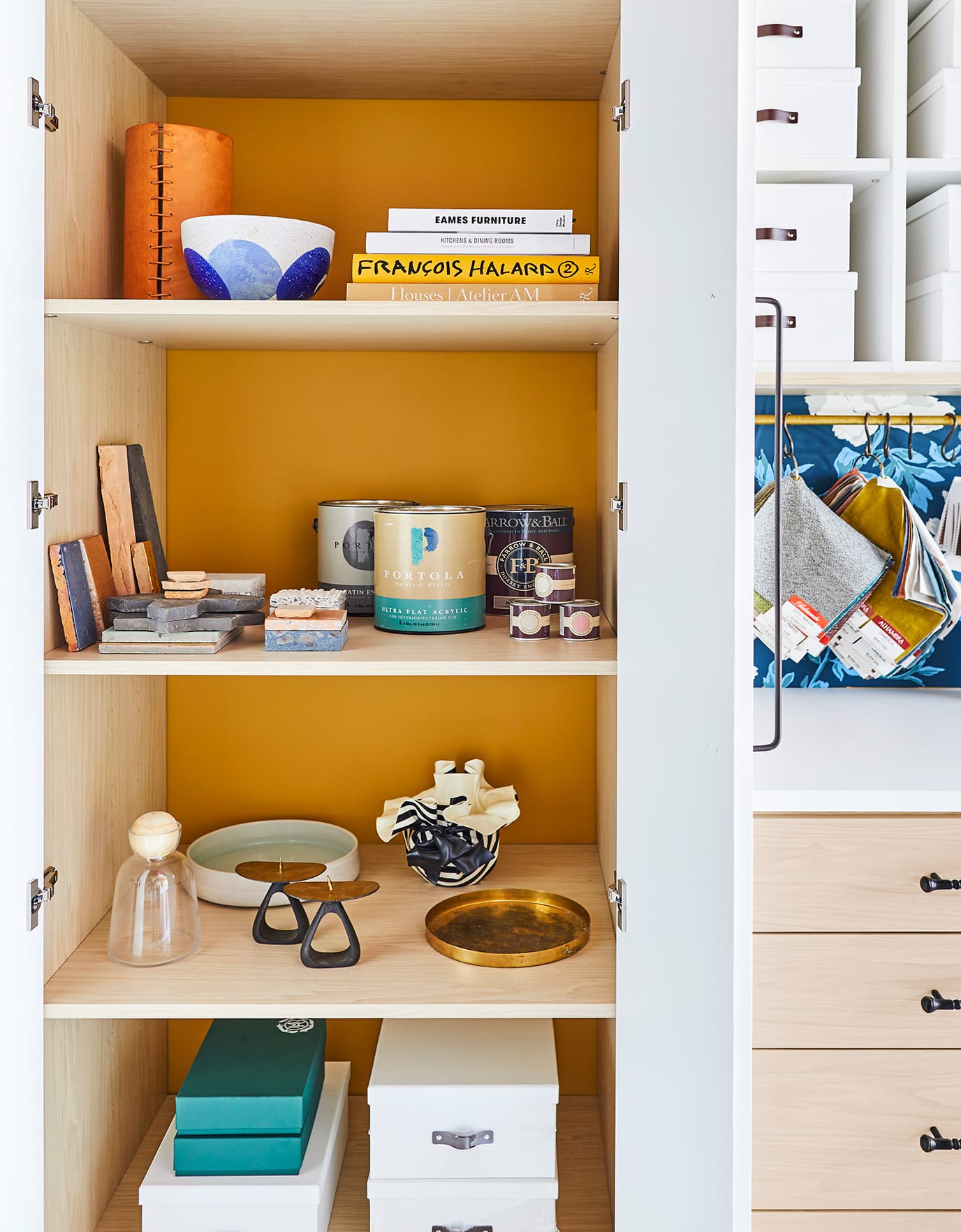 Custom shelves with multiple accessories and dresser with white counter top by California Closets