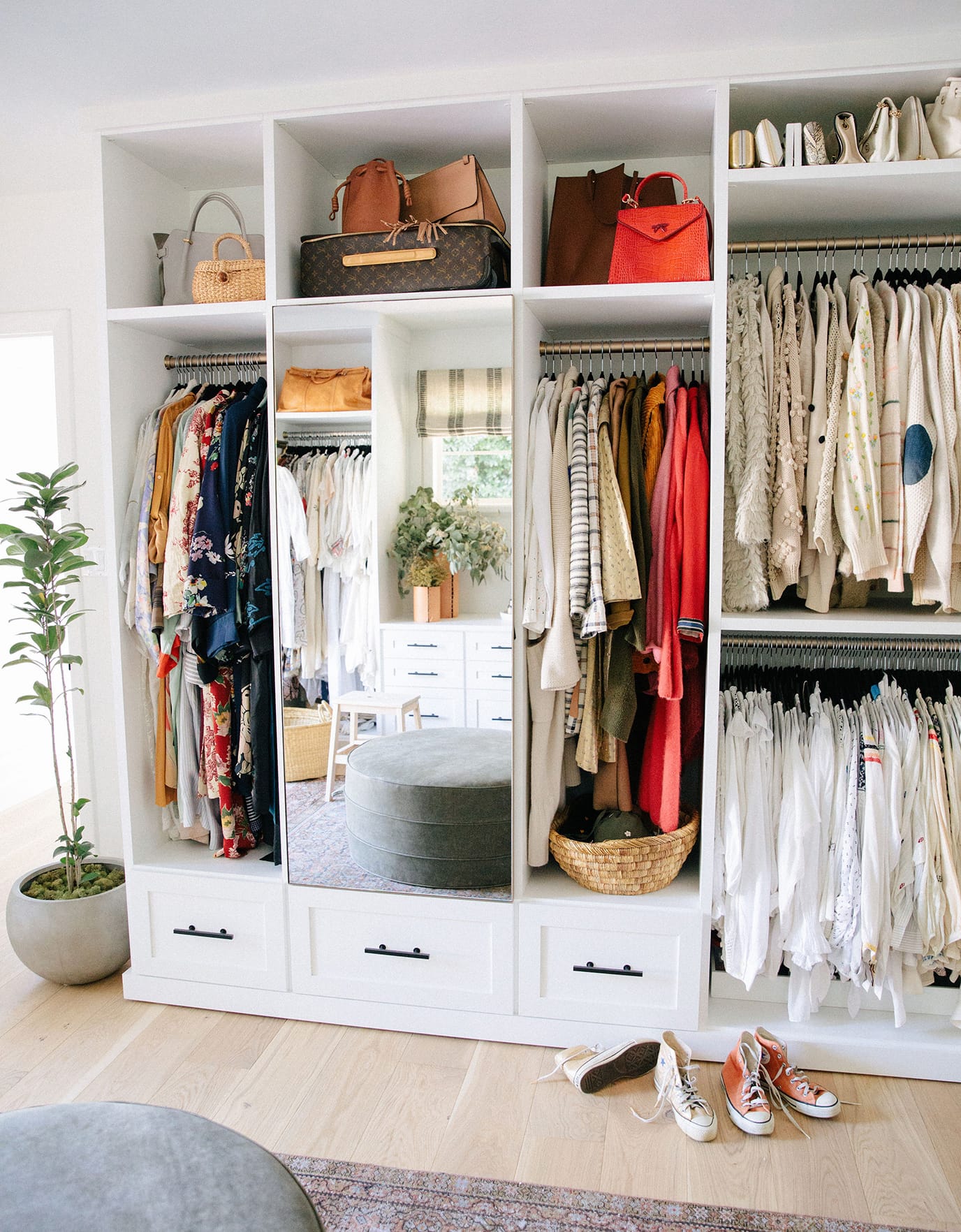 Custom closet hanging space and drawers for designer Emily Current, created by California Closets