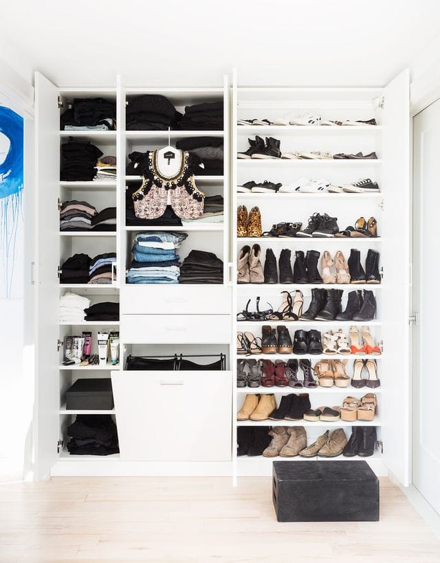 Reach in closet shelving and organized shoe storage racks with custom drawers by California Closets