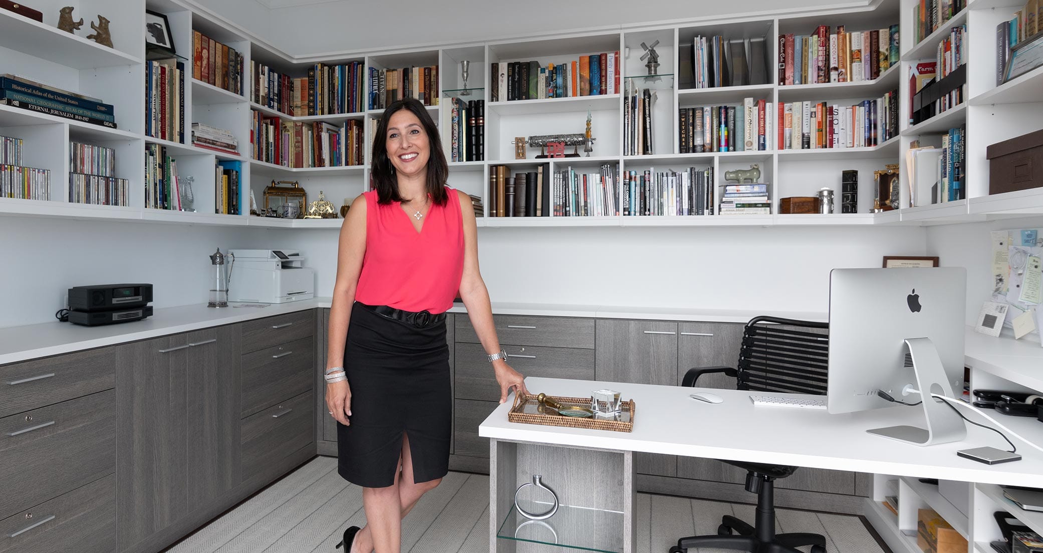 Office design with built in desk and custom bookshelves in white and grey finishes by California Closets