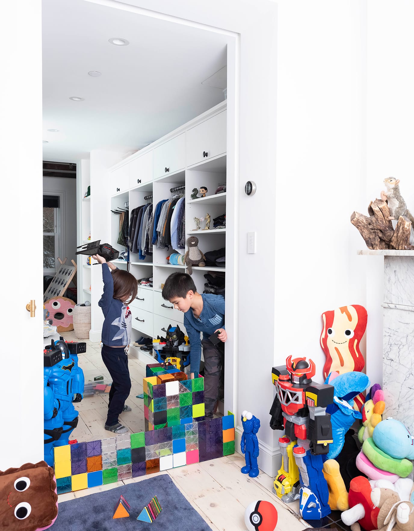 Kid's closet design with shelving, drawers and toy storage in white wood grain finish created by California Closets