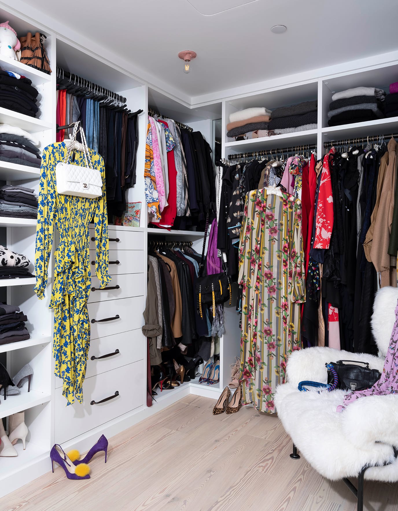 Blogger Olivia Song's custom walk in closet with built in shelving, dresser and shoe storage by California Closets