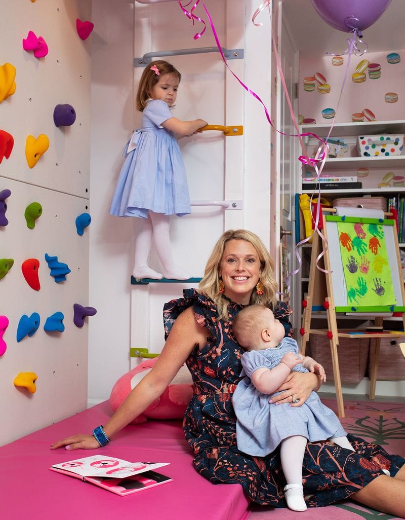 Parker Larson with her kids in a customized playroom with a climbing wall and bookshelves by California Closets