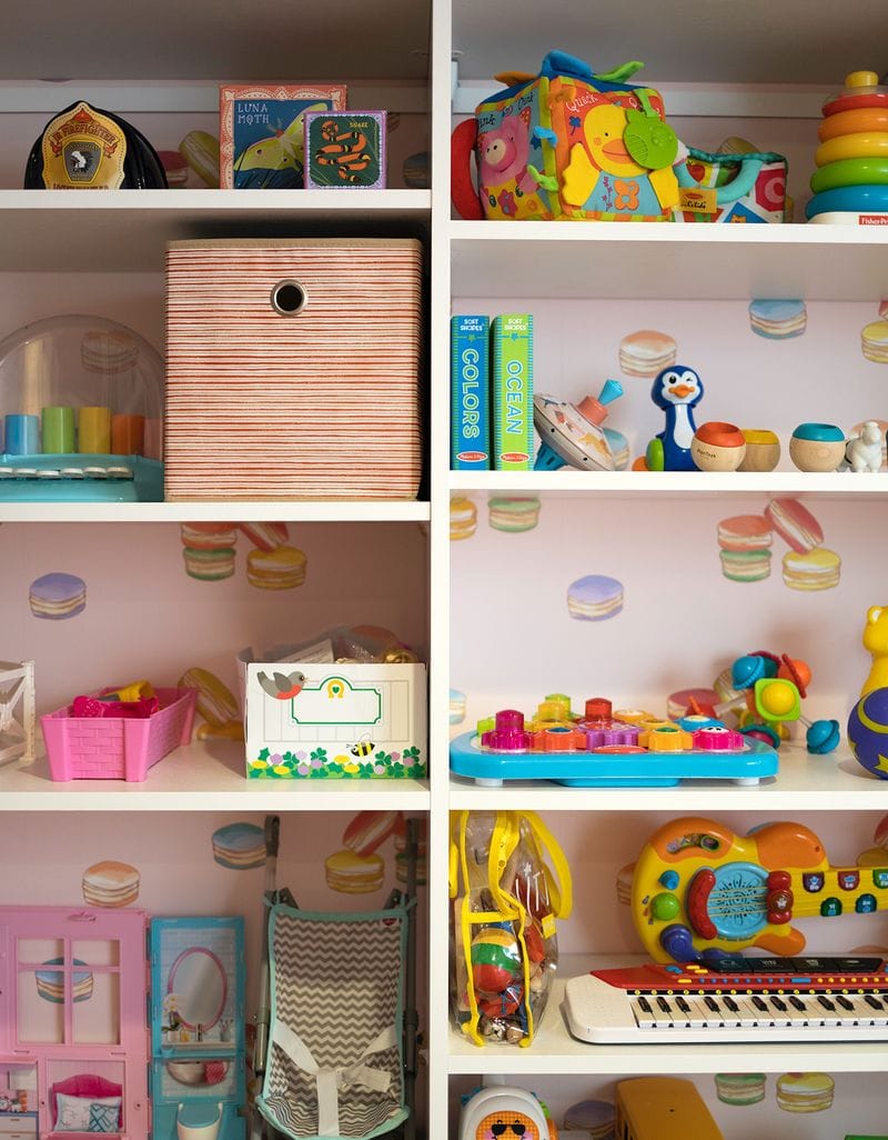 Playroom shelving for toy storage with wallpaper background by California Closets