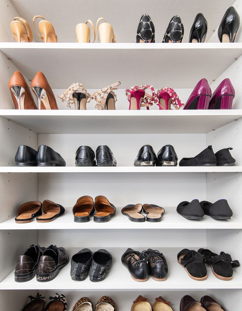 Custom shoe storage in Washington DC for Rachel Rosenthal and her husband in their walk in closets designed by California Closets