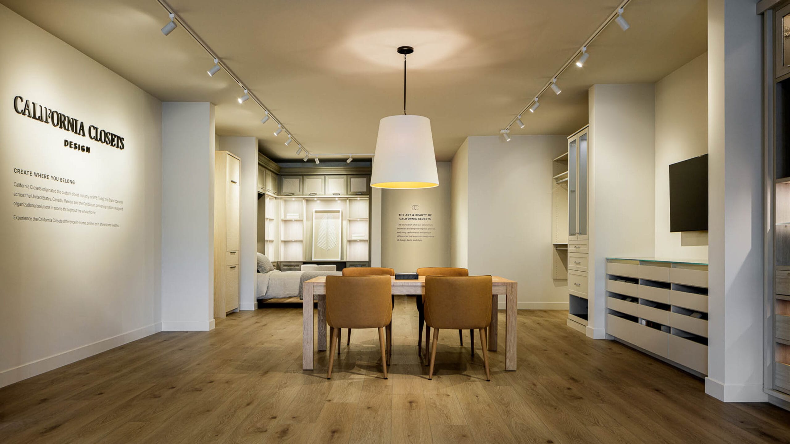 Showroom with storage cabinets and finishes samples at conference table California Closets