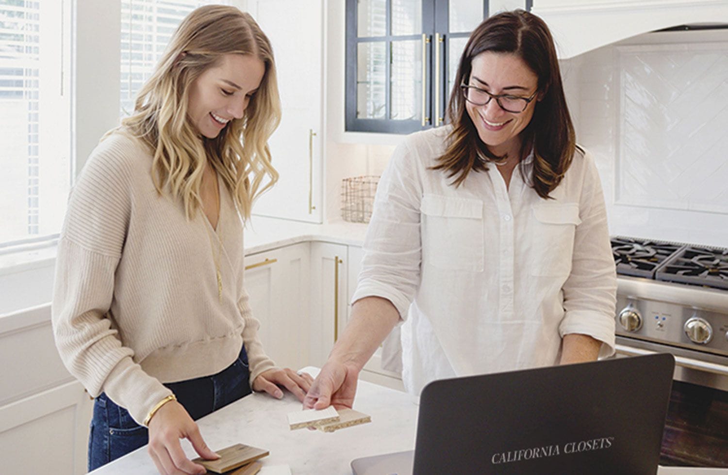 Design consultant meeting with customer to discuss custom closet plans with California Closets