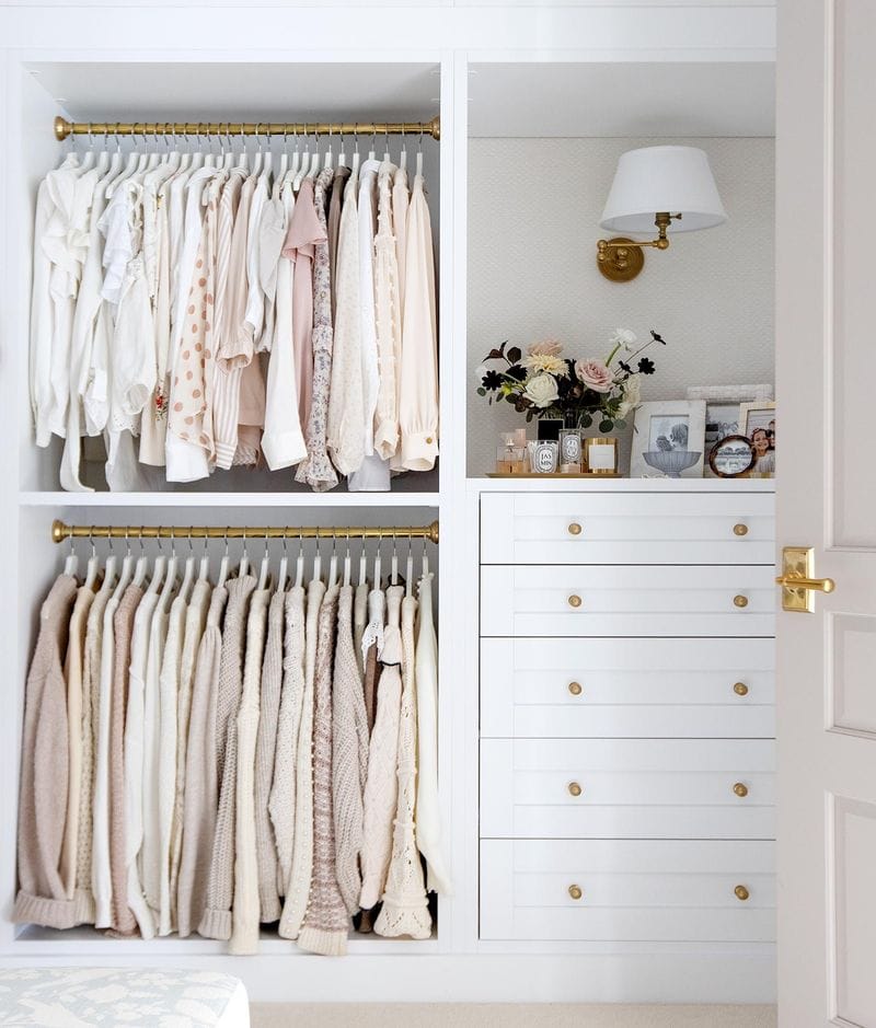 Reach in closet with built in dresser drawers in white finish by California Closets