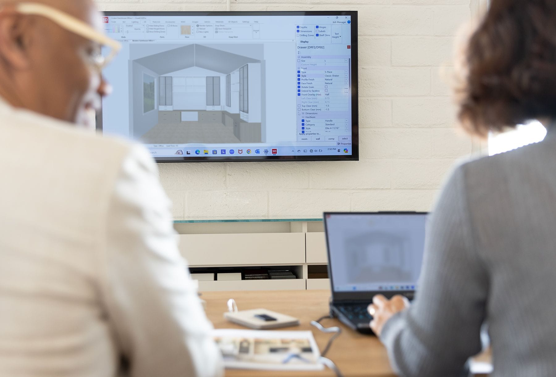 Designer reviews project plans during design consultation at a California Closets showroom
