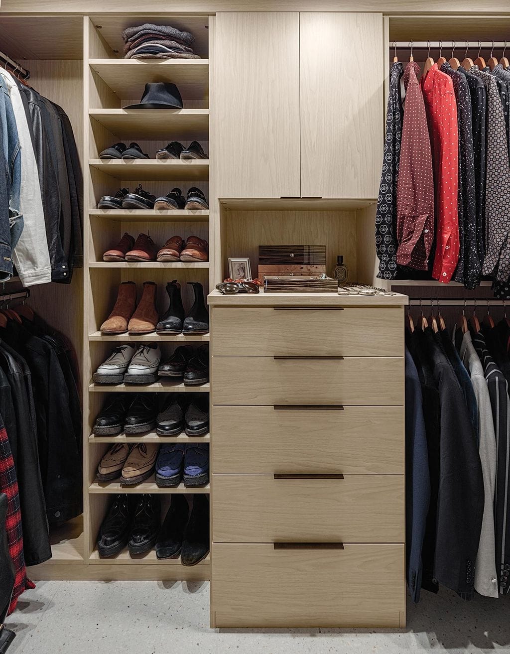 Closet redesigned for Matt Sorum to two walk in closets in wood grain finishes created by California Closets