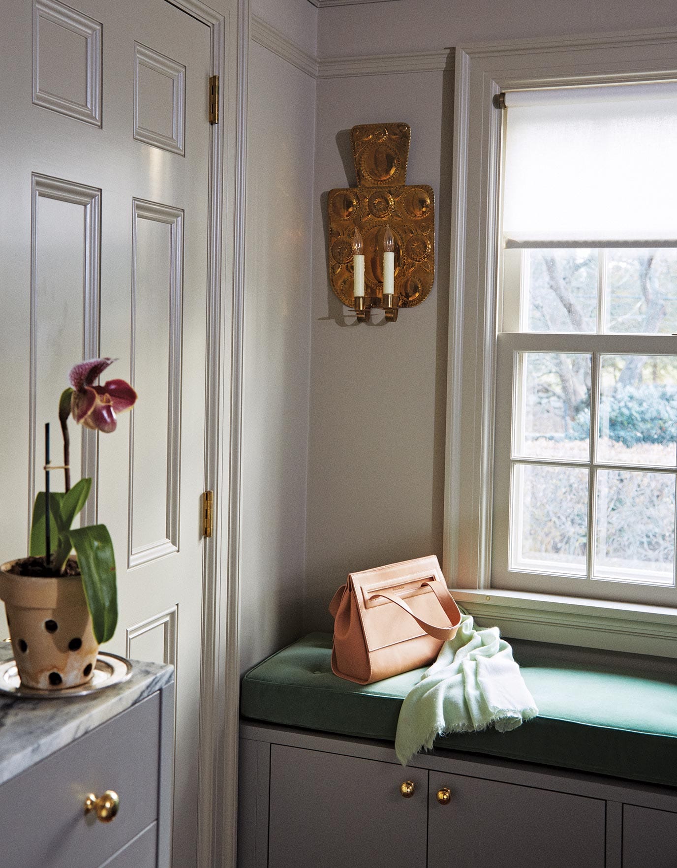 Martha Stewart's window bench with a velvet cushion storage seat and a comfortable spot to pull on shoes in Ideas of Order Magazine