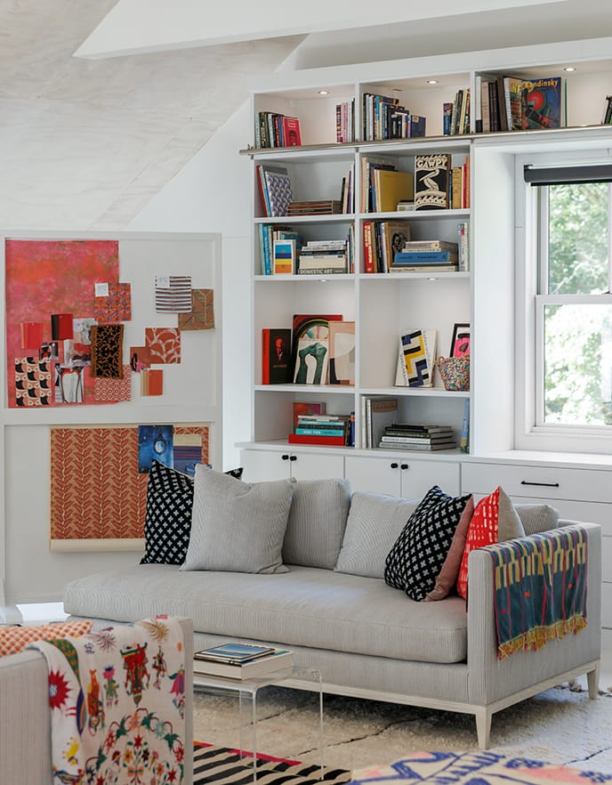 Built-in bookshelves and cabinetry in Serena Dugan's artistic, multifunctional guest room from California Closets