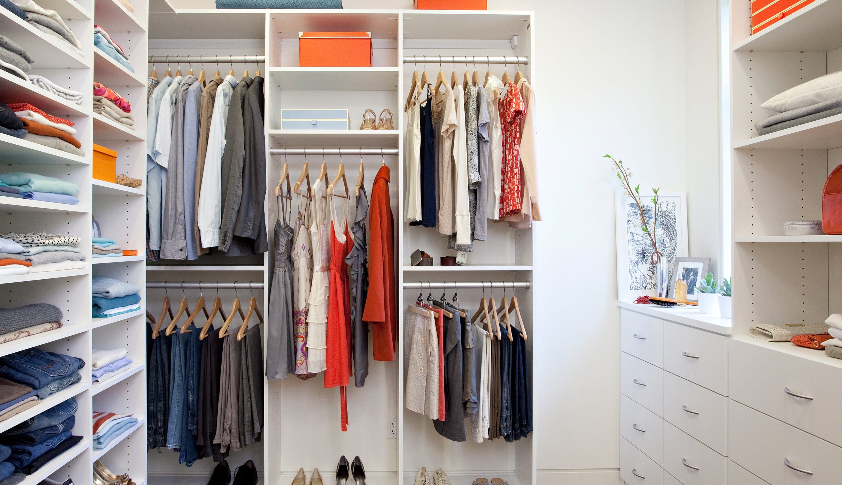Custom closet installed with shoe storage and shelving in white finish by California Closets