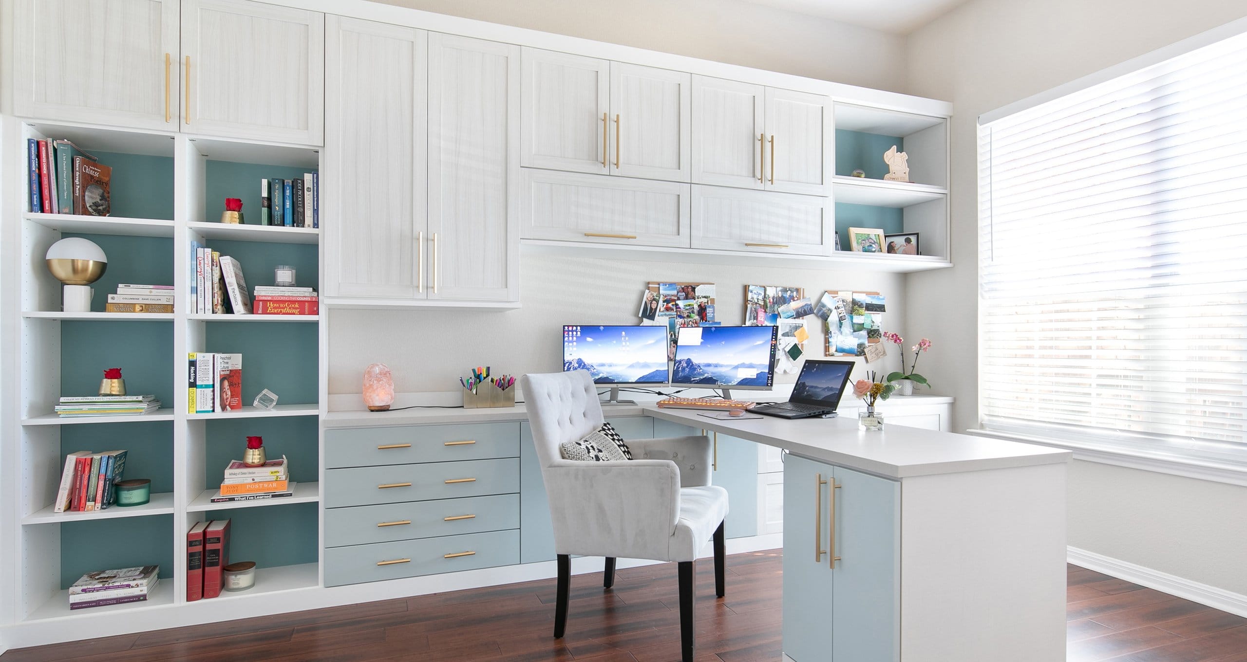 Home office in white wood finish with custom cabinets and built in desk created by California Closets