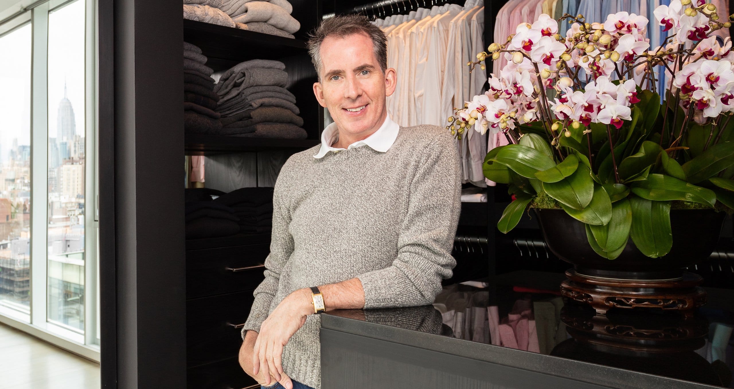 Kevin Sharkey's customized closet design with extra wardrobe hanging space in dark finish by California Closets
