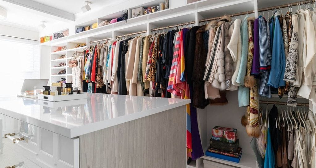 Center island storage drawers and open shelving for Susan Magrino's closet by California Closets