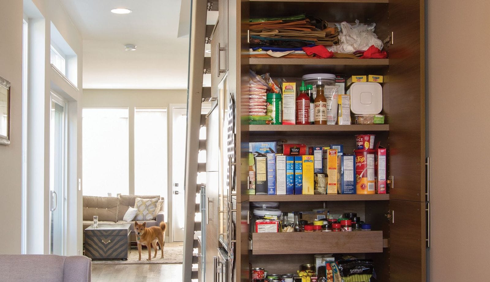 Custom kitchen pantry installed with pull out drawers designed understairs by California Closets
