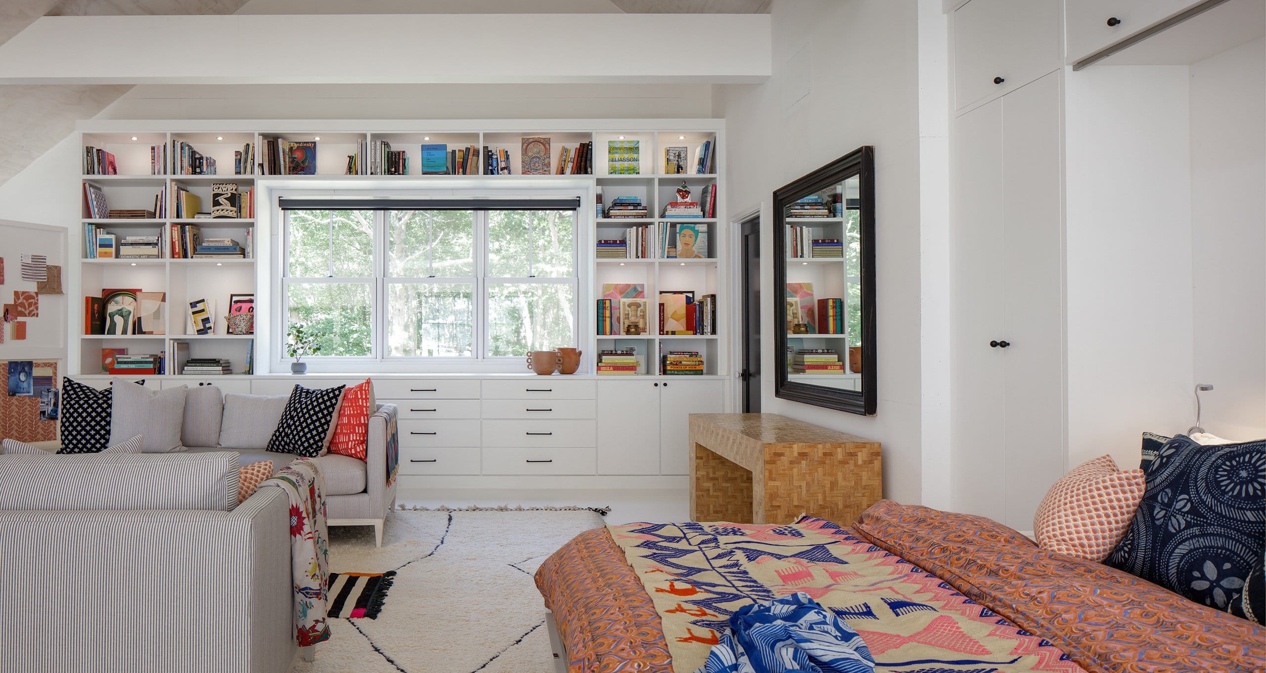 Opened wall bed doubles function for this artistic barn loft-like studio with built in bookshelves and art supply storage from California Closets