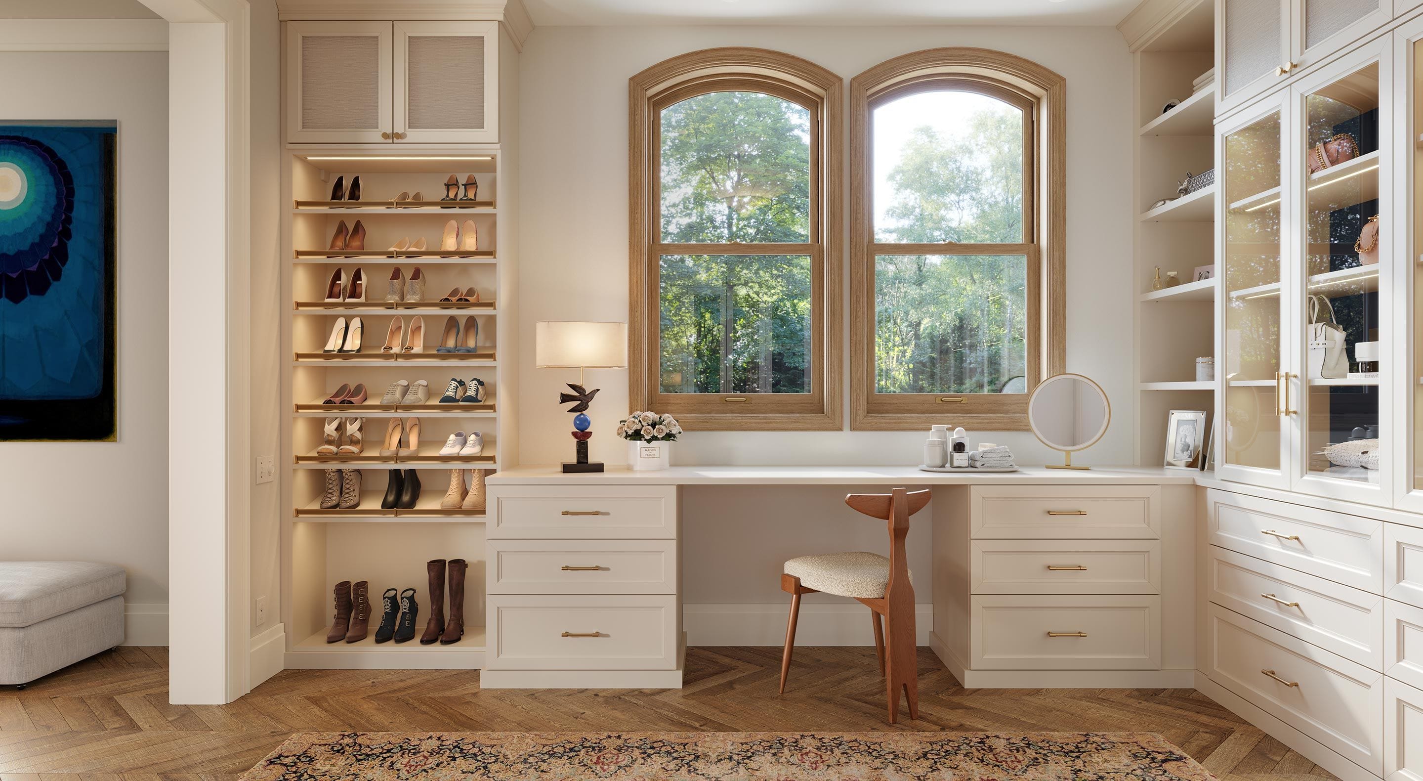 Walk in closet with desk and vanity and lighted shoe storage shelving from California Closets